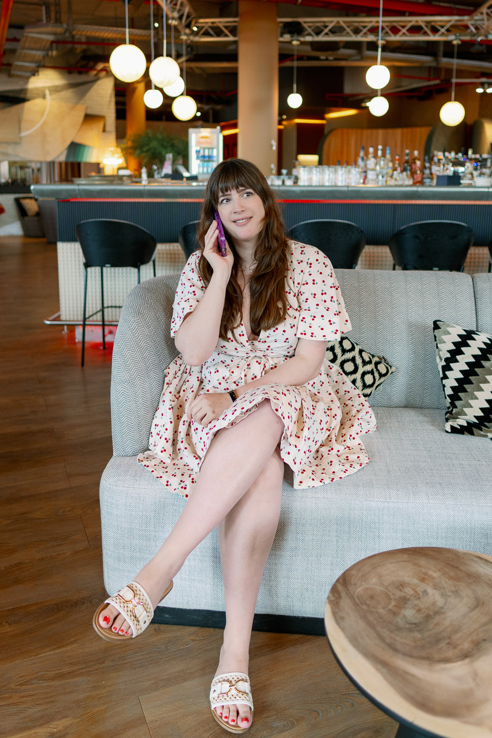 Andrea von andysparkles sitzt in einer Hotellobby auf dem Sofa und telefoniert, was kann man einer Frau immer schenken als Geschenkidee für jeden Anlass